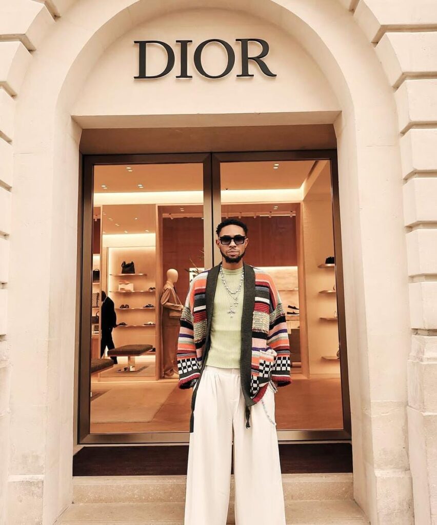 crispdal in frony of a dior shop 